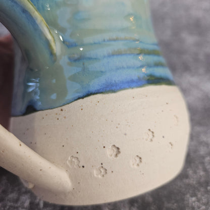 Paw prints in the sand mug