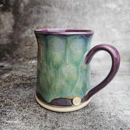 Flowing ice, green over purple mug with ear shape handle