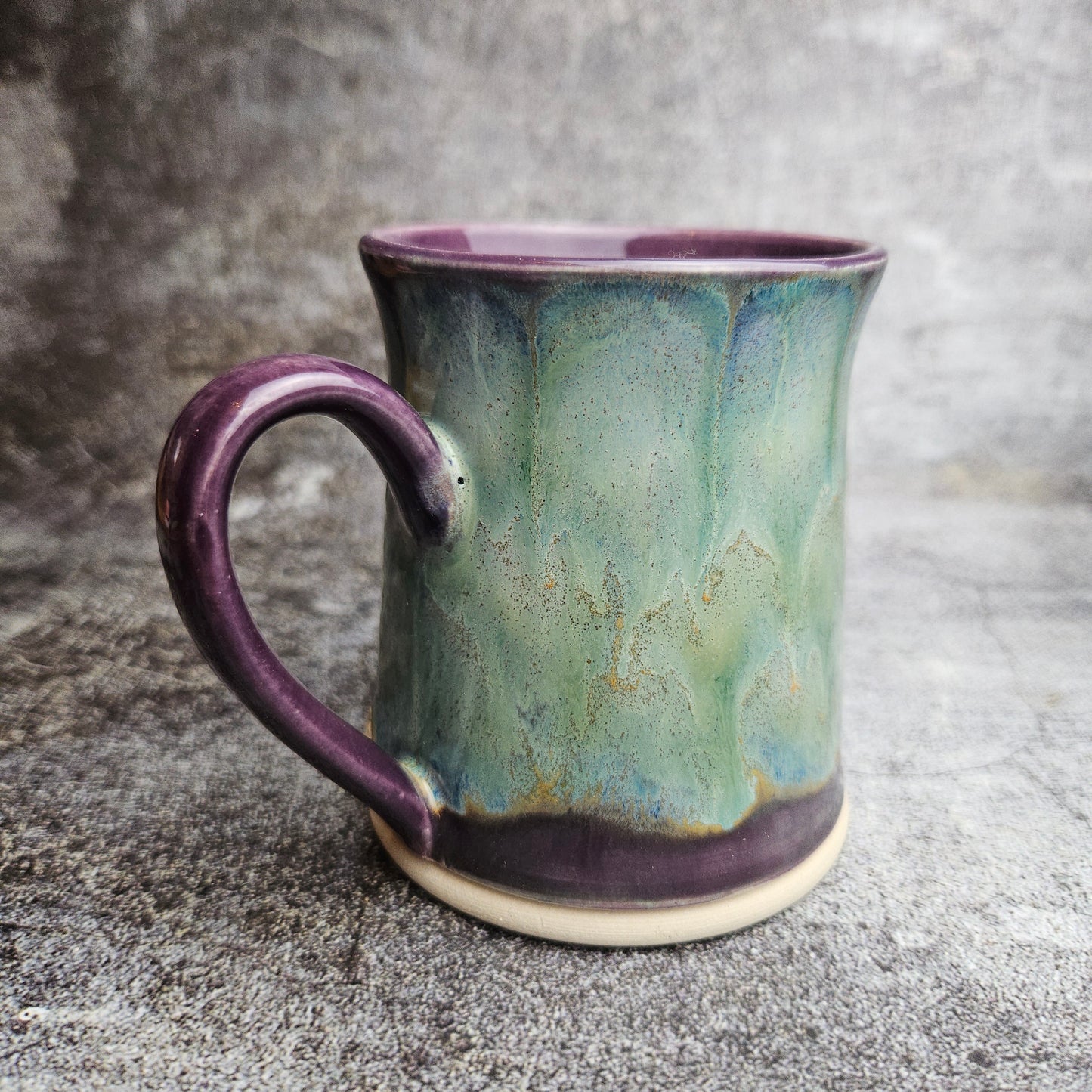 Flowing ice, green over purple mug with ear shape handle