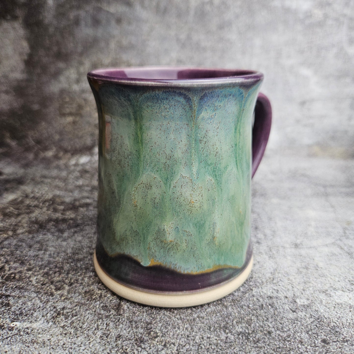 Flowing ice, green over purple mug with ear shape handle
